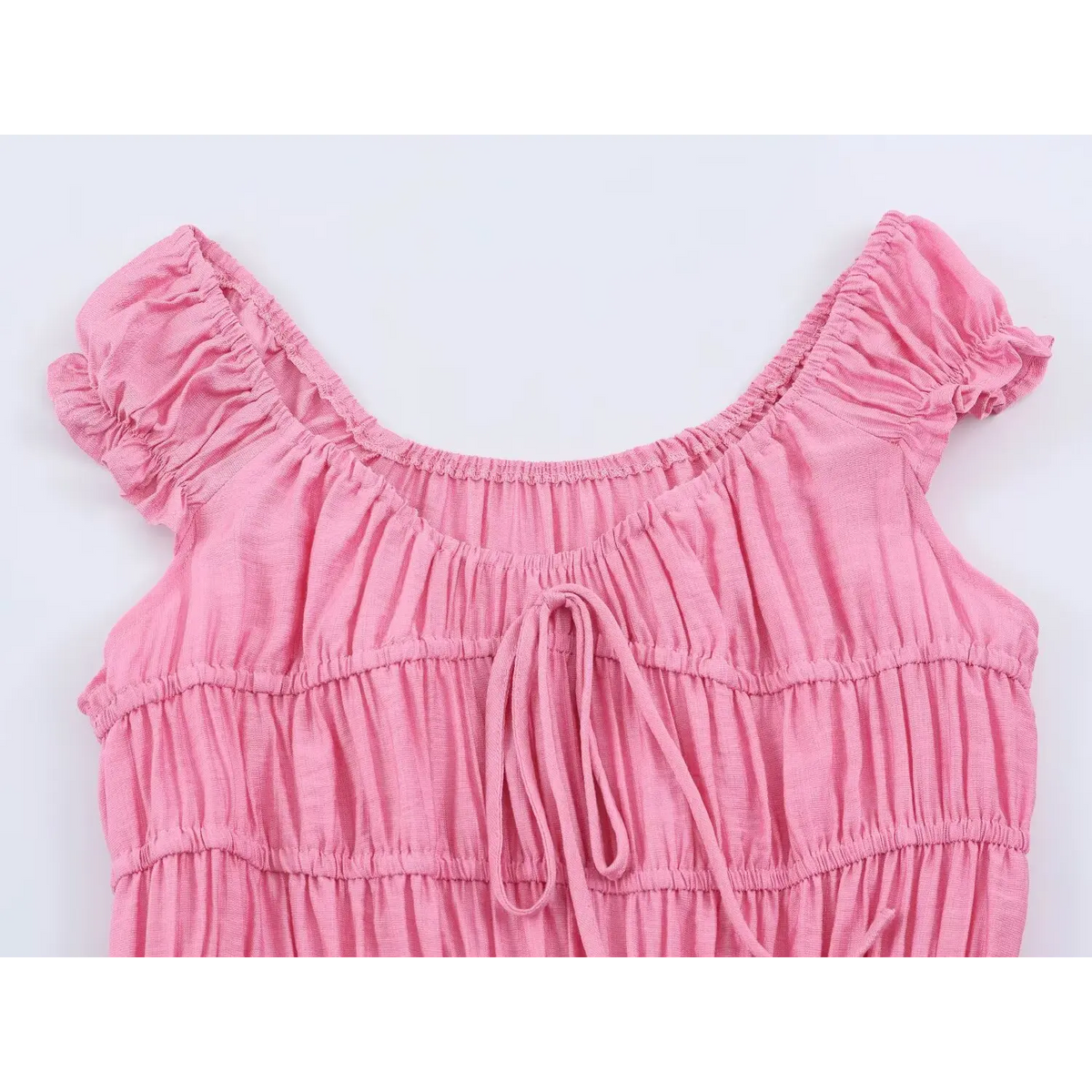Close‑up of square neck smocked bodice with front tie detail