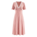 Front view of pink white polka dot maxi dress with lace v‑neck and short puff sleeves