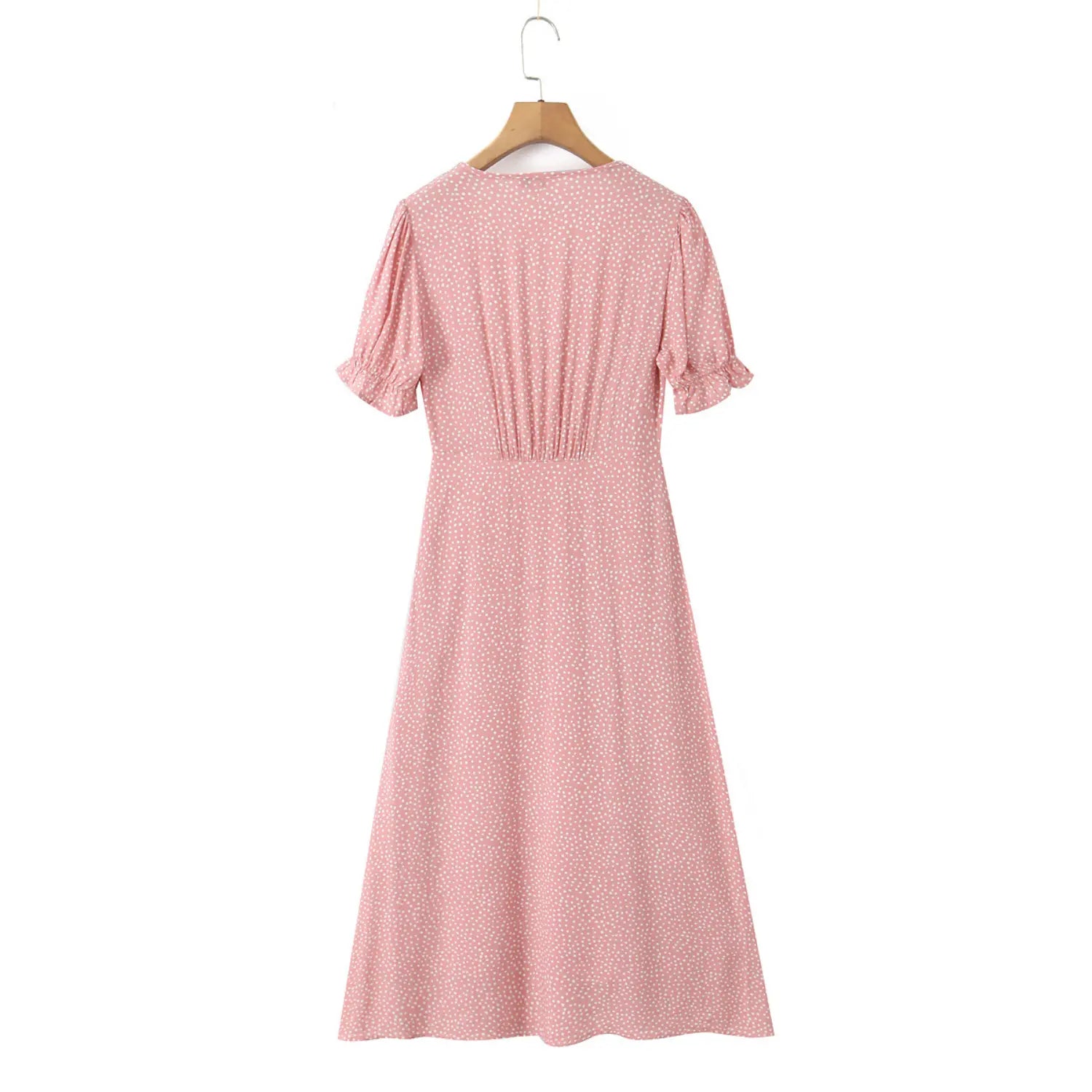 Full back view of pink polka dot maxi dress hanging on wooden hanger