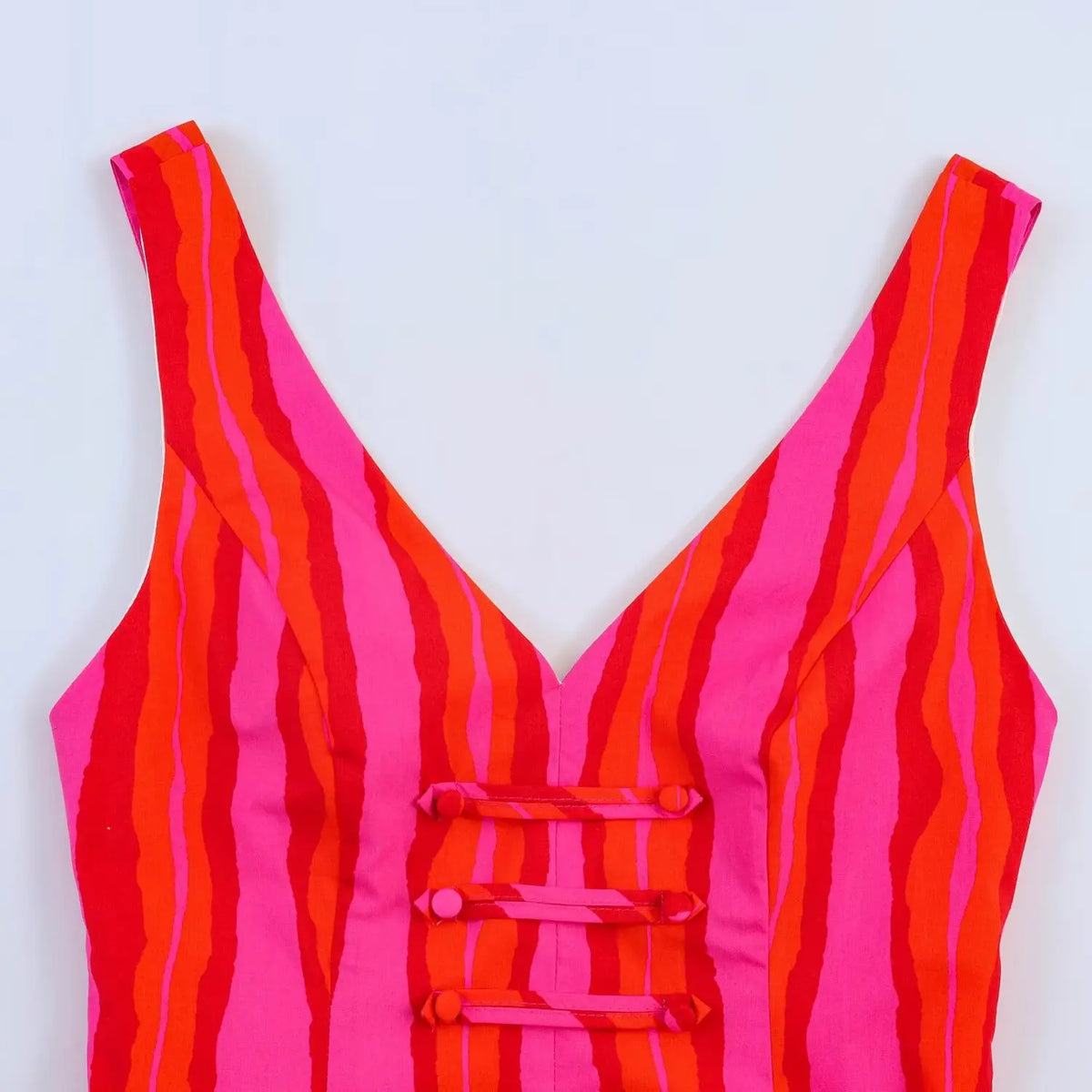 Close‑up of v‑neck bodice with lace‑up back design and stripe print