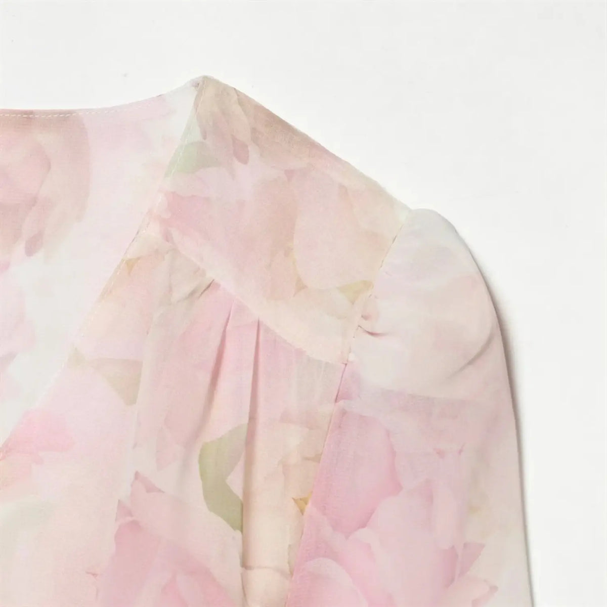 Close‑up of short flutter sleeve and shoulder seam detail