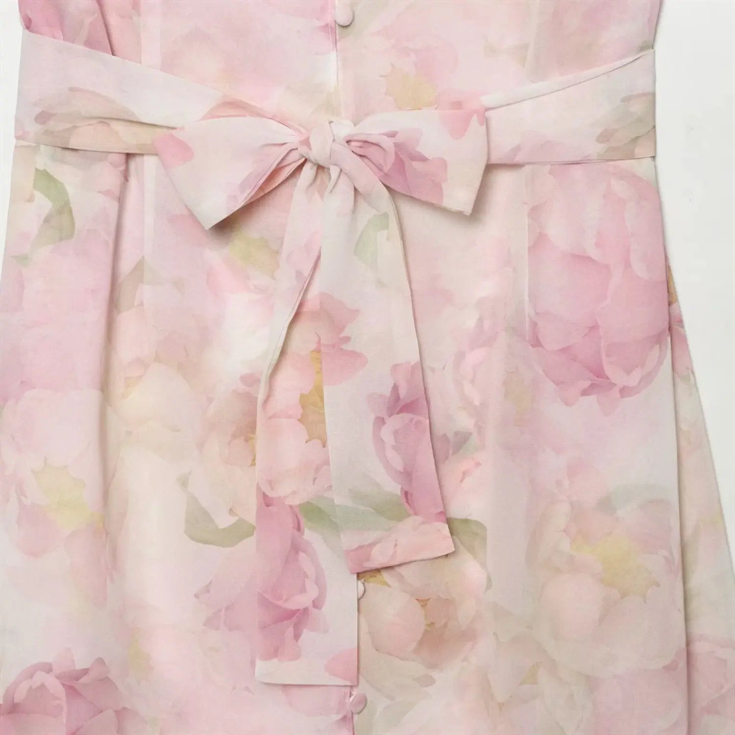 Close‑up of fabric waist tie bow detail