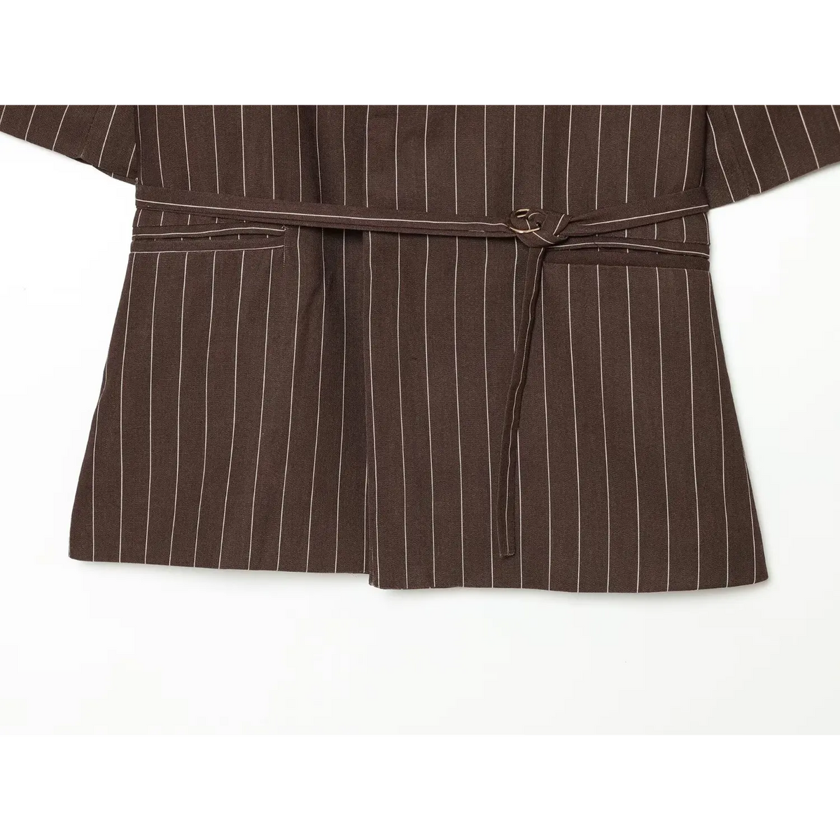 Close-up of belted waist and hem flat lay