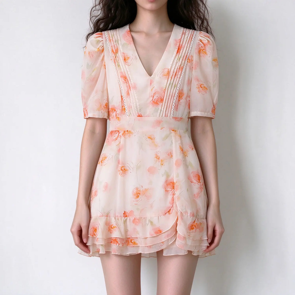 Model wearing pink watercolor rose pintuck lace trim ruffle hem mini dress, front view