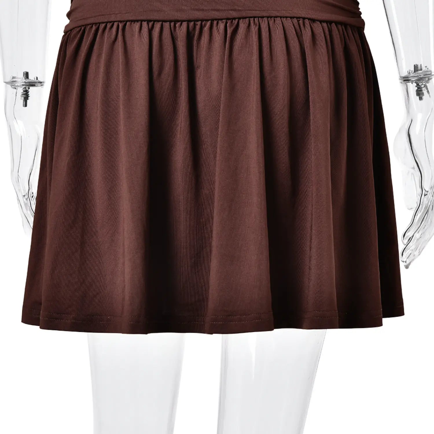 Flowy gathered pleated skirt hem detail of brown halter dress