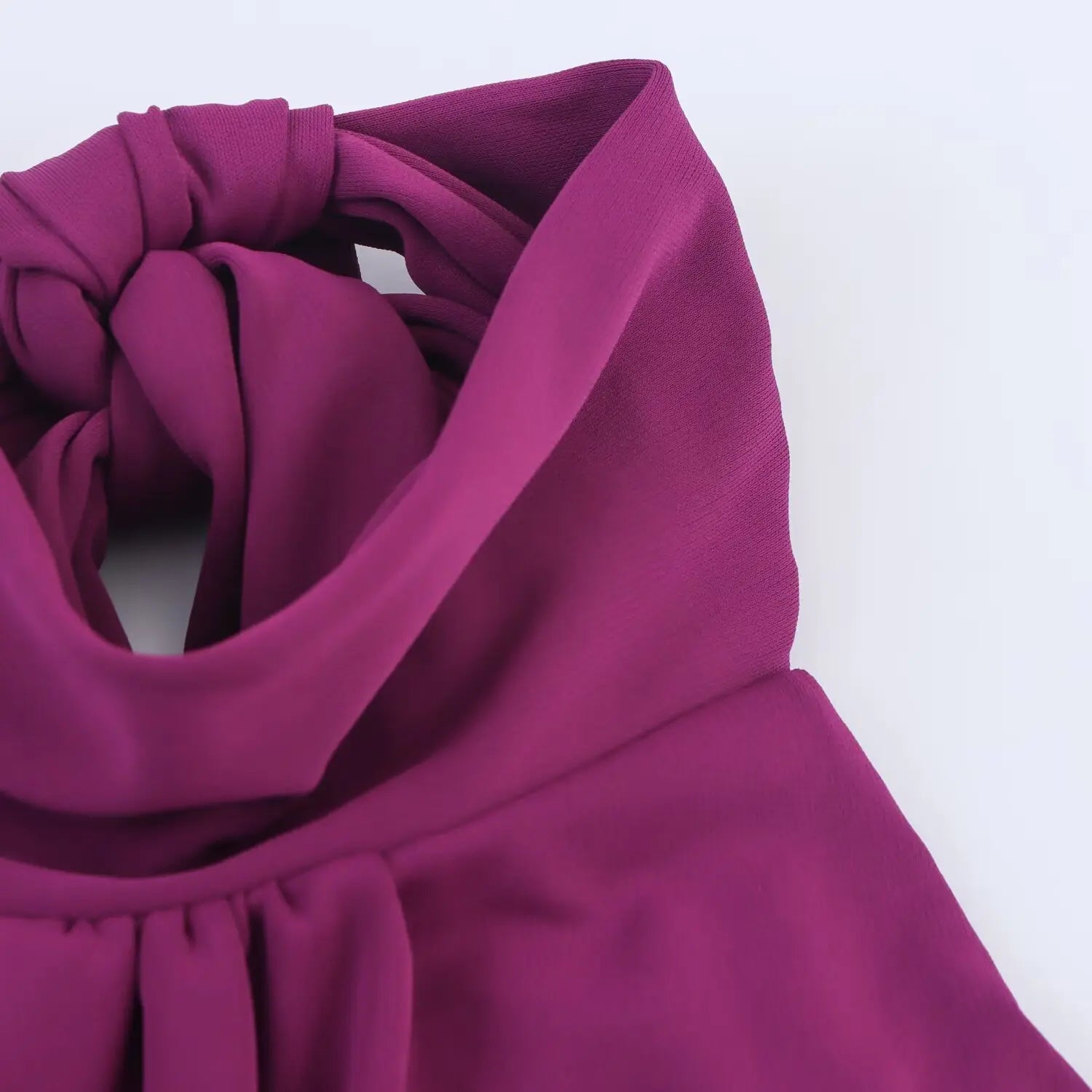 Macro shot of halter neck back bow knot detail on plum cutout midi dress