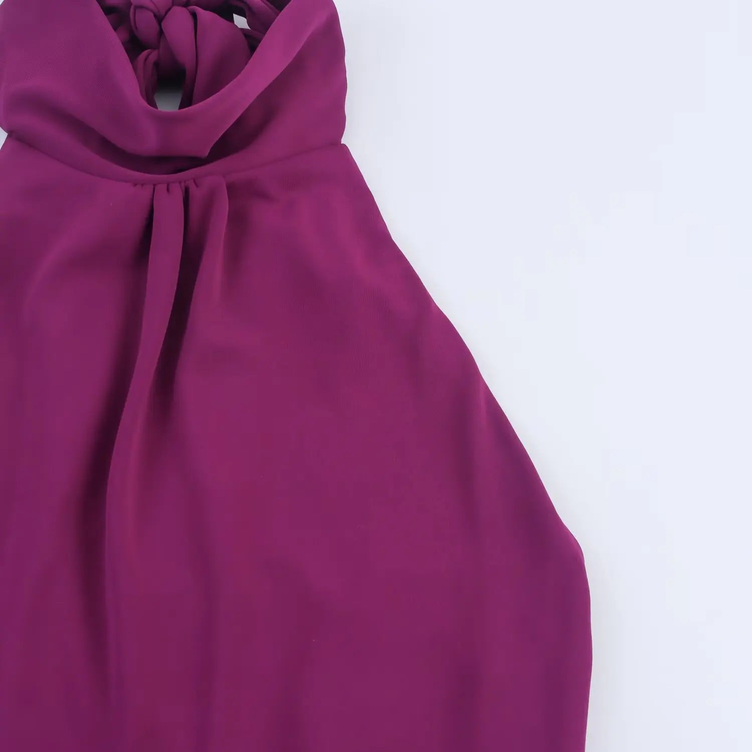 Close‑up shot of halter neck pleats on plum bodycon midi dress