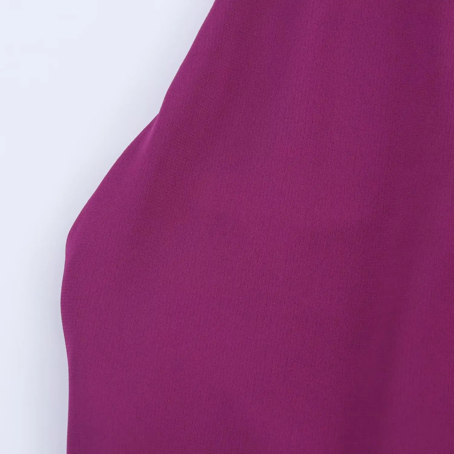 Macro close‑up of soft stretch knit fabric texture of plum halter midi dress
