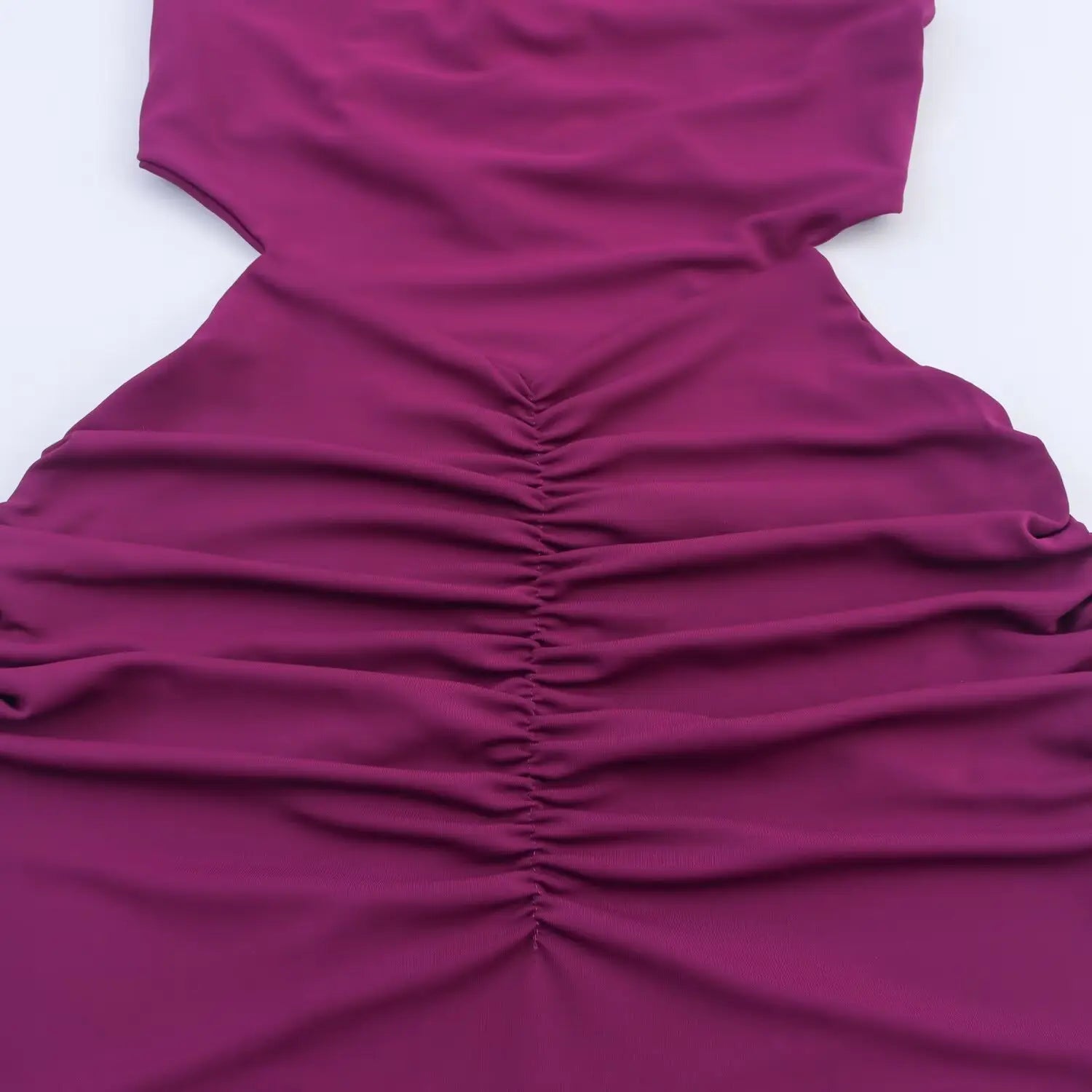 Close‑up of waist cutout and center front ruched gathering detail for plum midi dress
