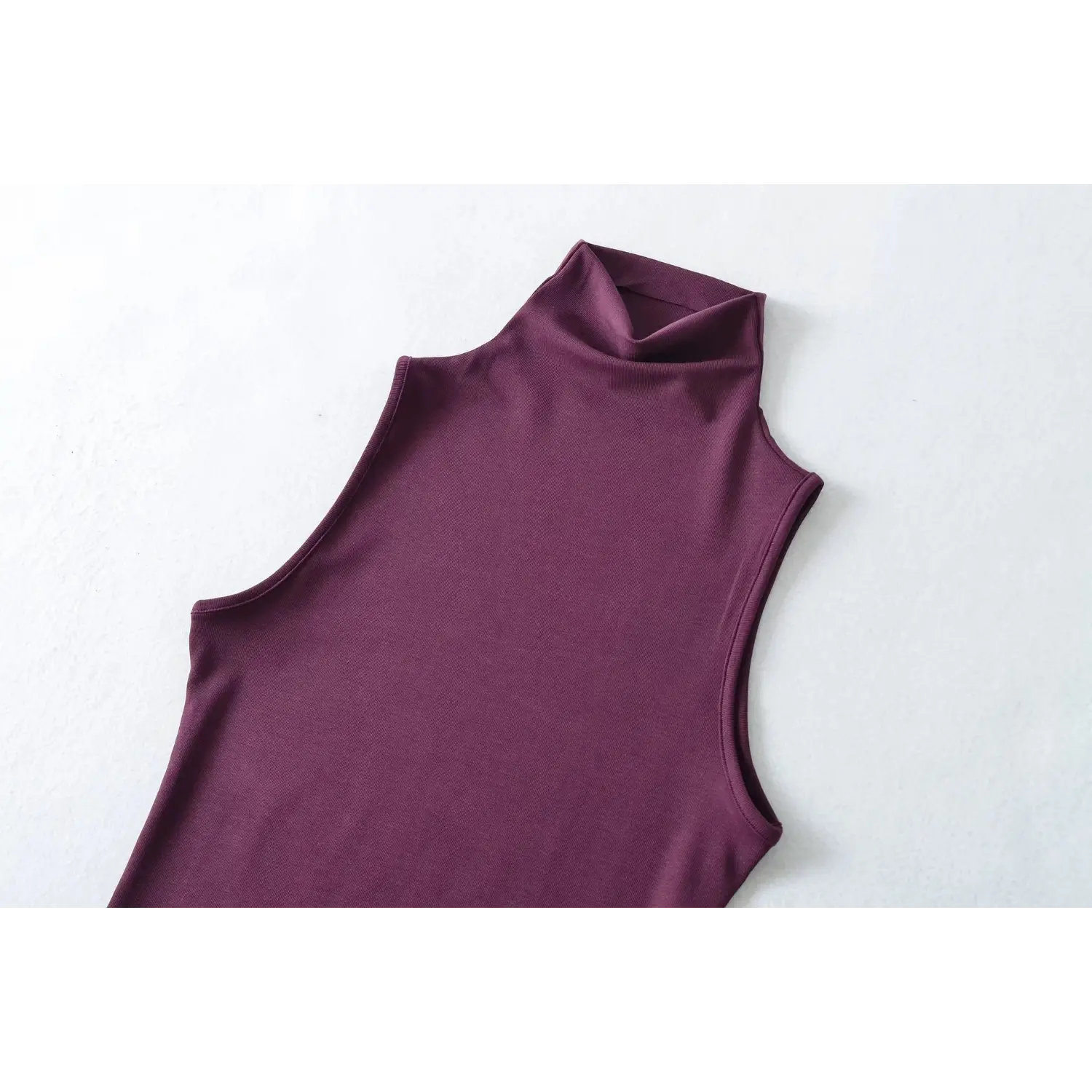 Partial front detail shot, plum sleeveless high neck tank top, showcase fabric texture and armhole cutting