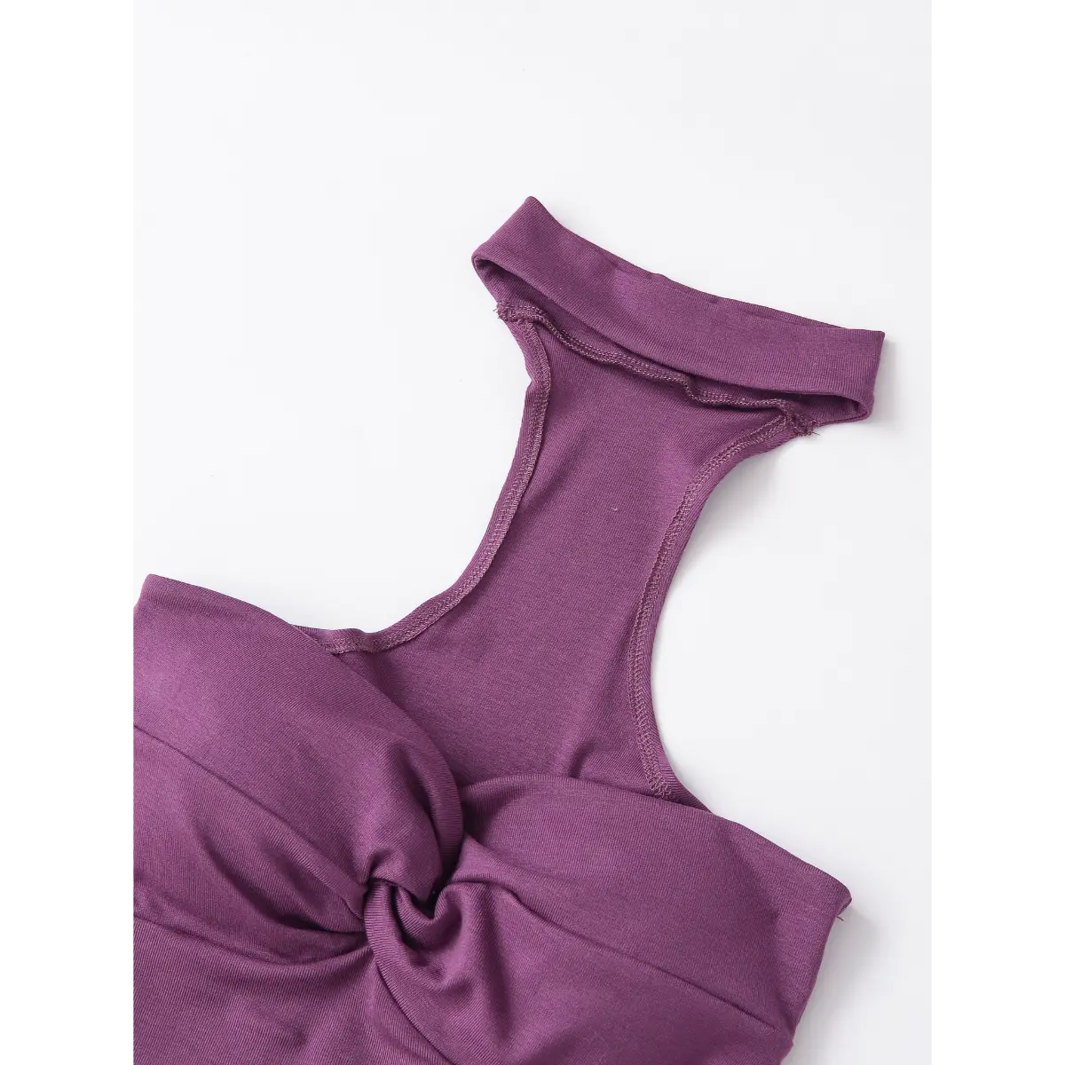 Front view of the plum halter top, highlighting the twist detail, halter neckline, and cropped silhouette.