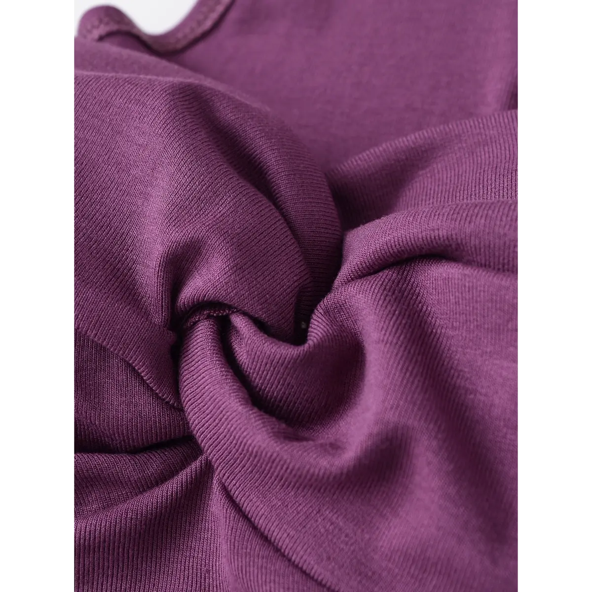 Close-up of the central twist detail, showing the fabric's soft texture and knit pattern.