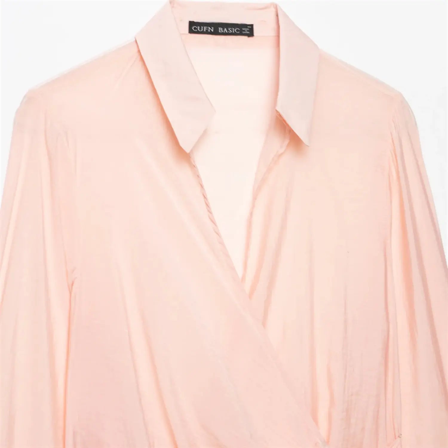 Extreme close-up of lapel neck stand, wrap V inner placket, thin translucent satin weave, natural fabric folds