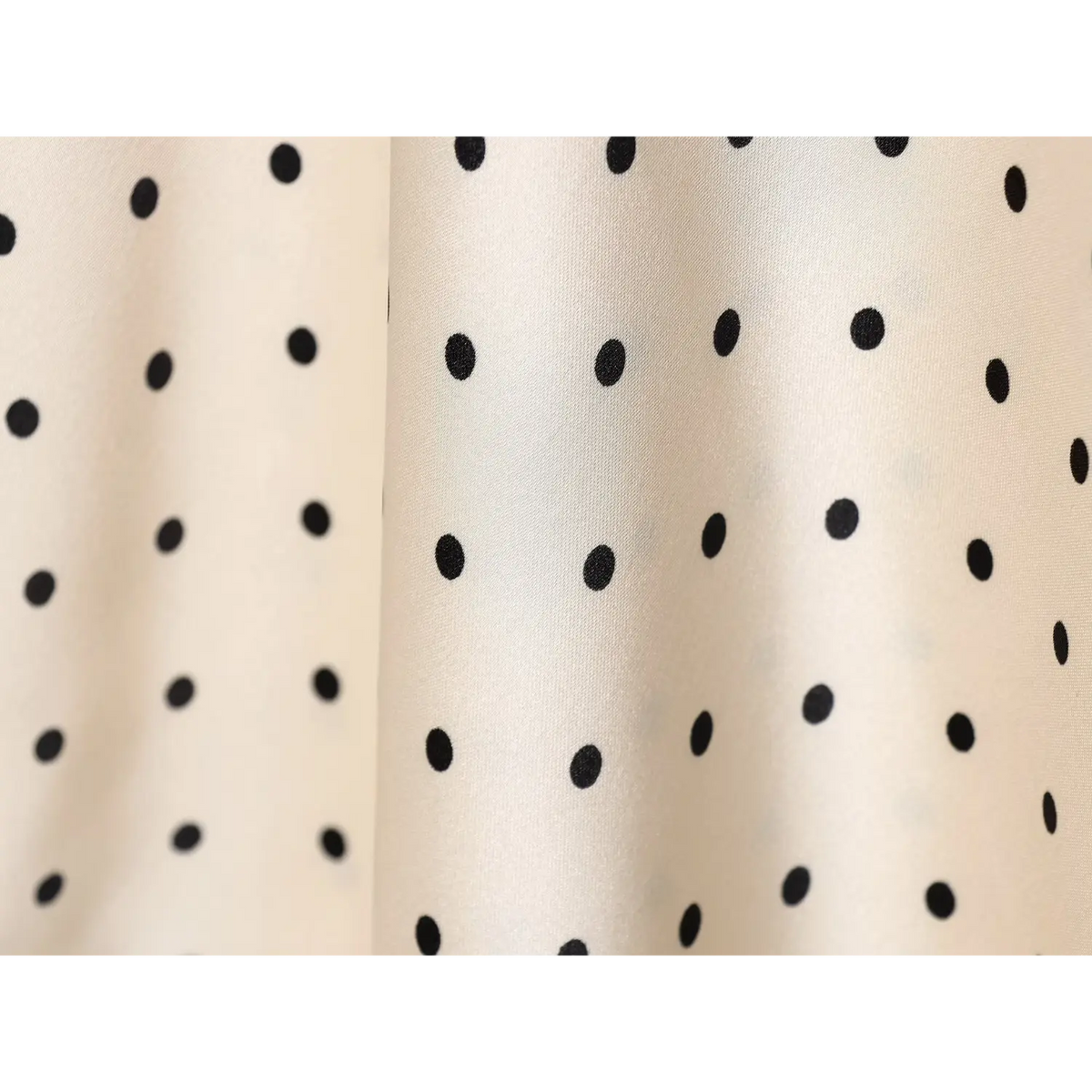 Close-up of satin dot print fabric texture