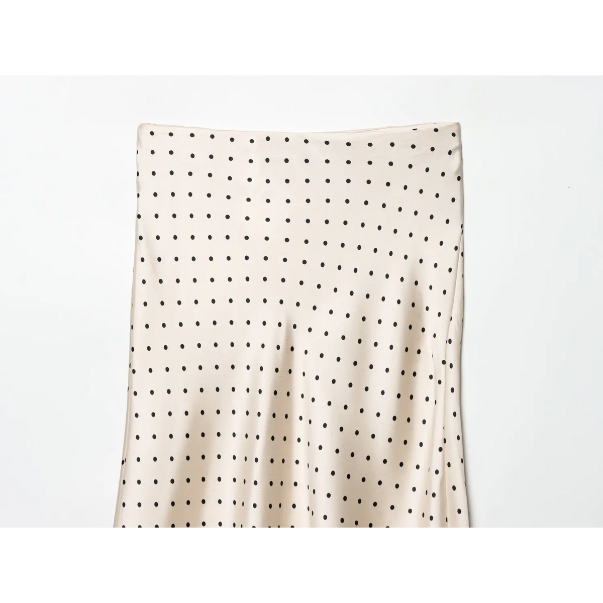 Close-up of straight waistband and dot print