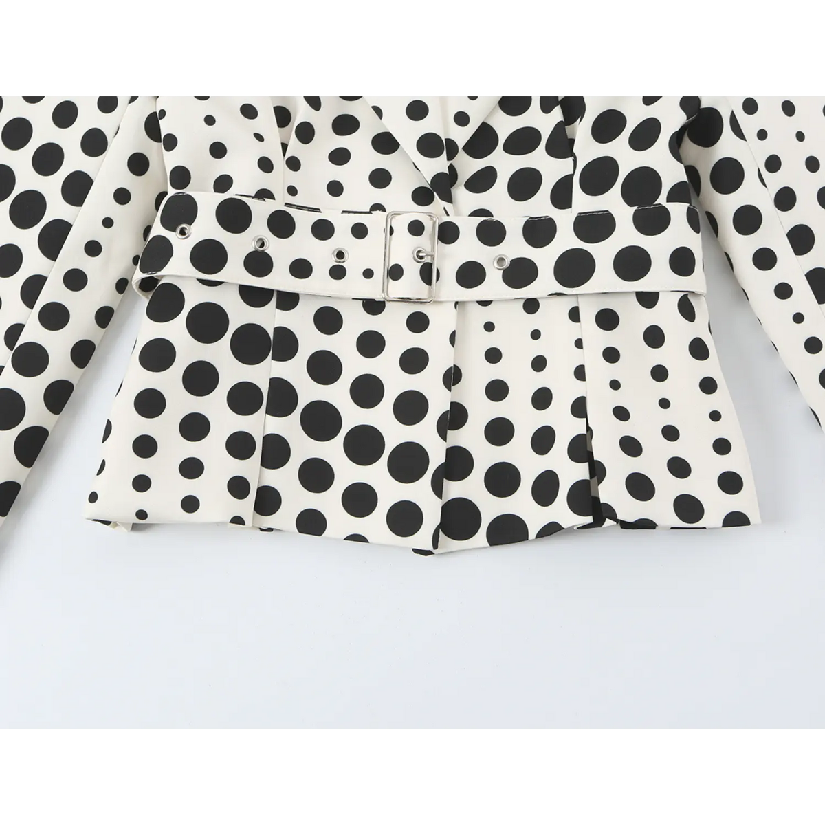 Close-up of belt and pleated peplum hem