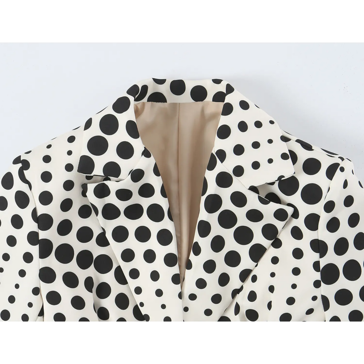 Close-up of notched lapel and polka dot print