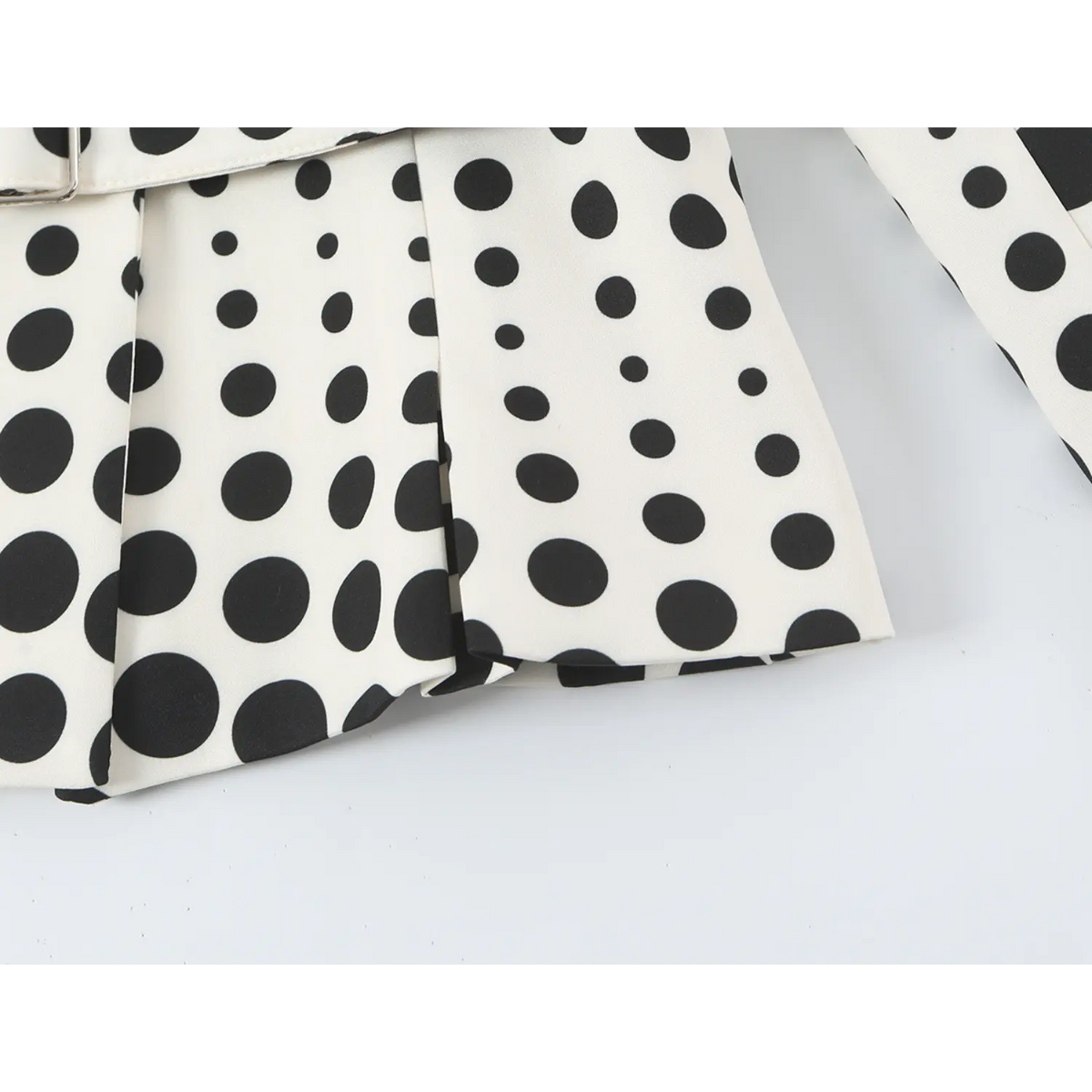 Close-up of peplum hem and polka dot print