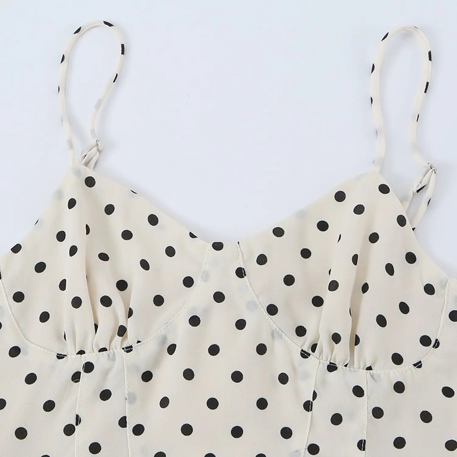 Black dot cream chiffon cami v-neck bust close-up flat lay, 3d gathered bust and polka dot printed chiffon stitching fabric detail