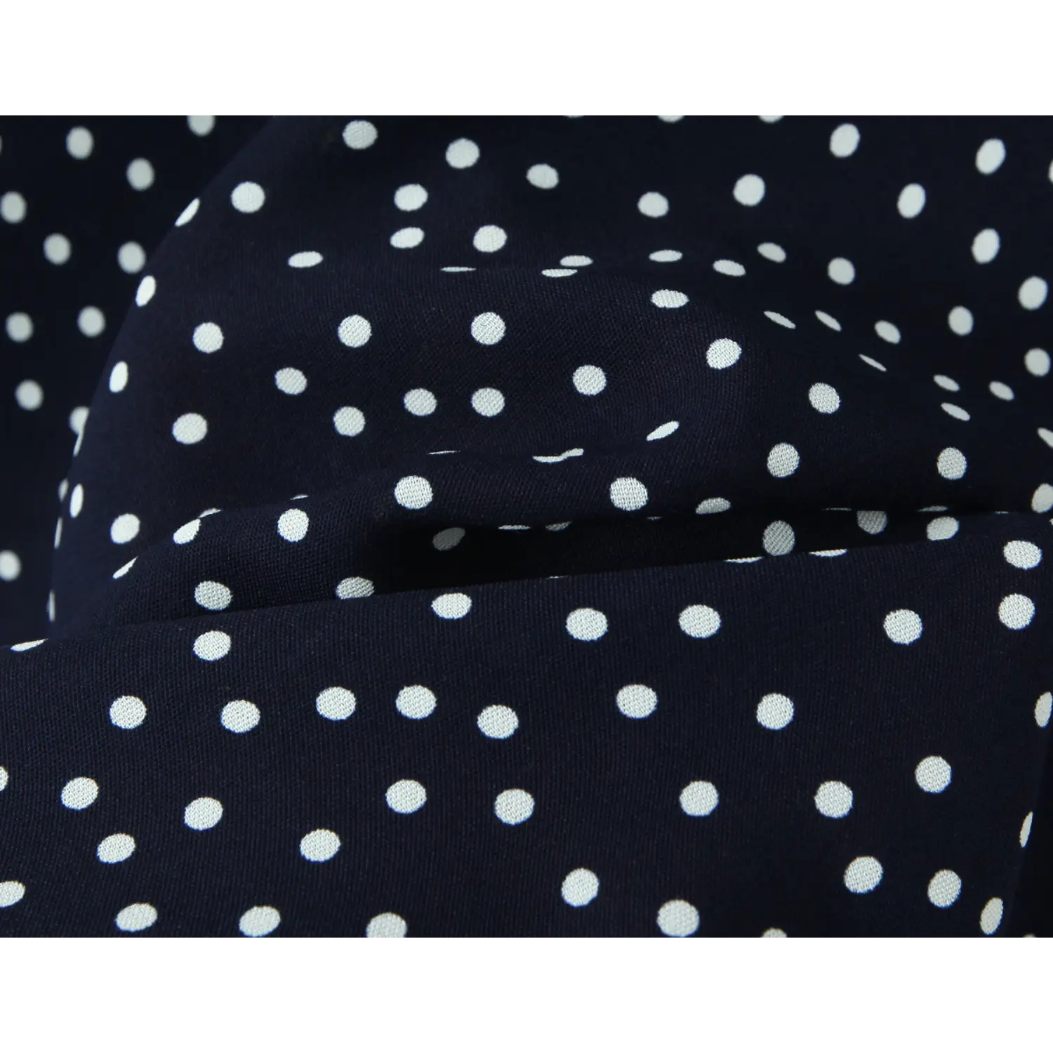 Navy polka dot chiffon fabric fold texture macro flat close-up, soft smooth sheer uniform white dot print lightweight spring summer dress cloth shot