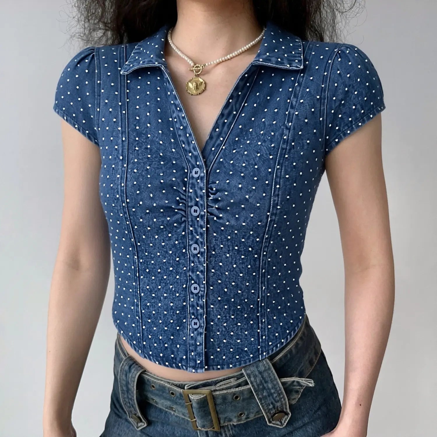 Front lifestyle full shot on model, pointed lapel collar, cap puff short sleeves, front bust ruching & button placket, fitted cropped waist, matched with matching denim bottoms, vintage retro daily collocation