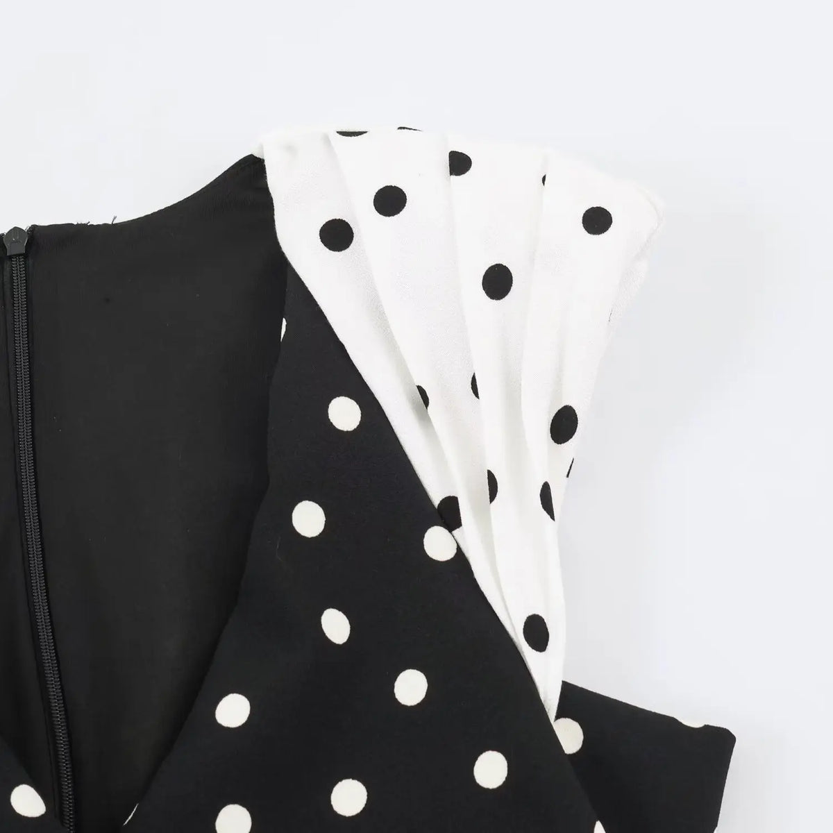 Macro detail of contrast pleated cap sleeve mixed polka dot print