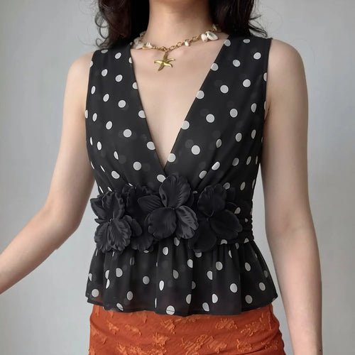 Model front wearing lifestyle shot, show real fit of polka dot 3D flower peplum cami top
