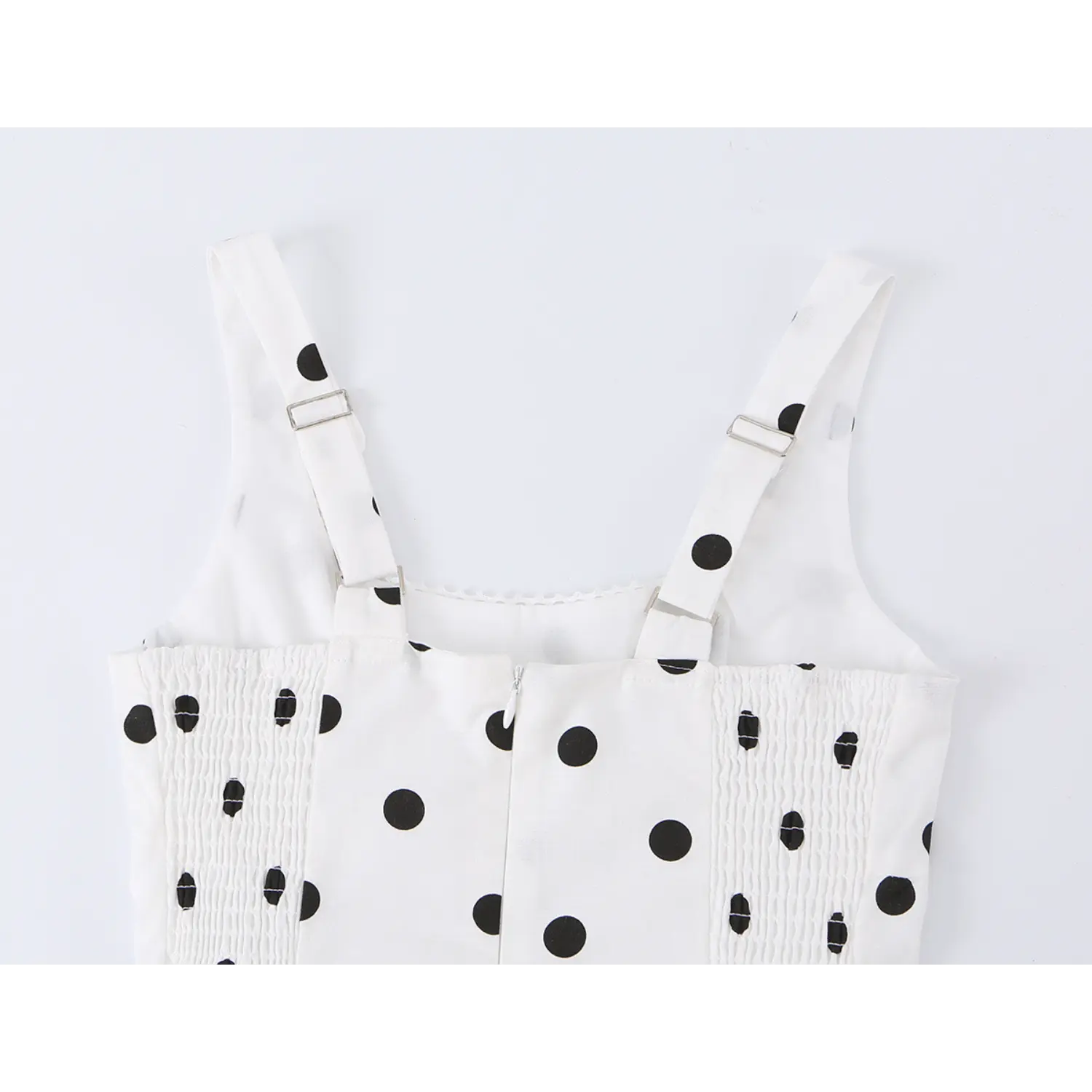 White black dot mini cami dress back flat detail, adjustable buckle wide straps full smocked waist invisible back zipper white background shot