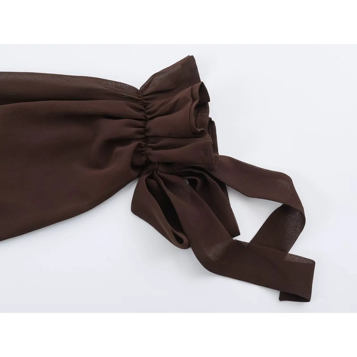 Close-up of elastic cuff with fabric tie bow