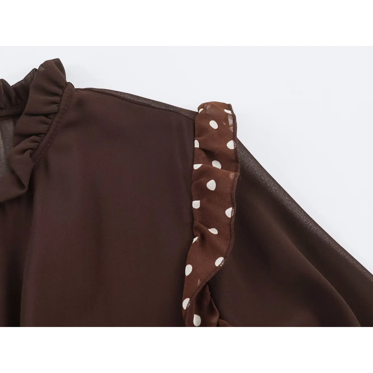 Close-up of polka dot ruffle shoulder trim