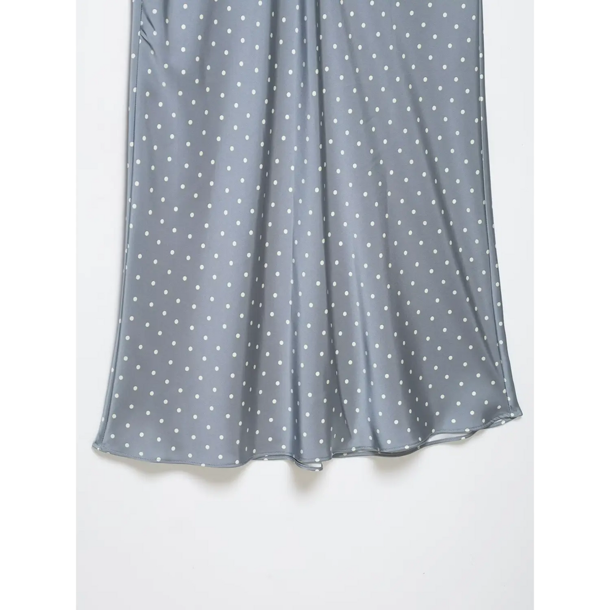Close-up of flowing skirt hem drape