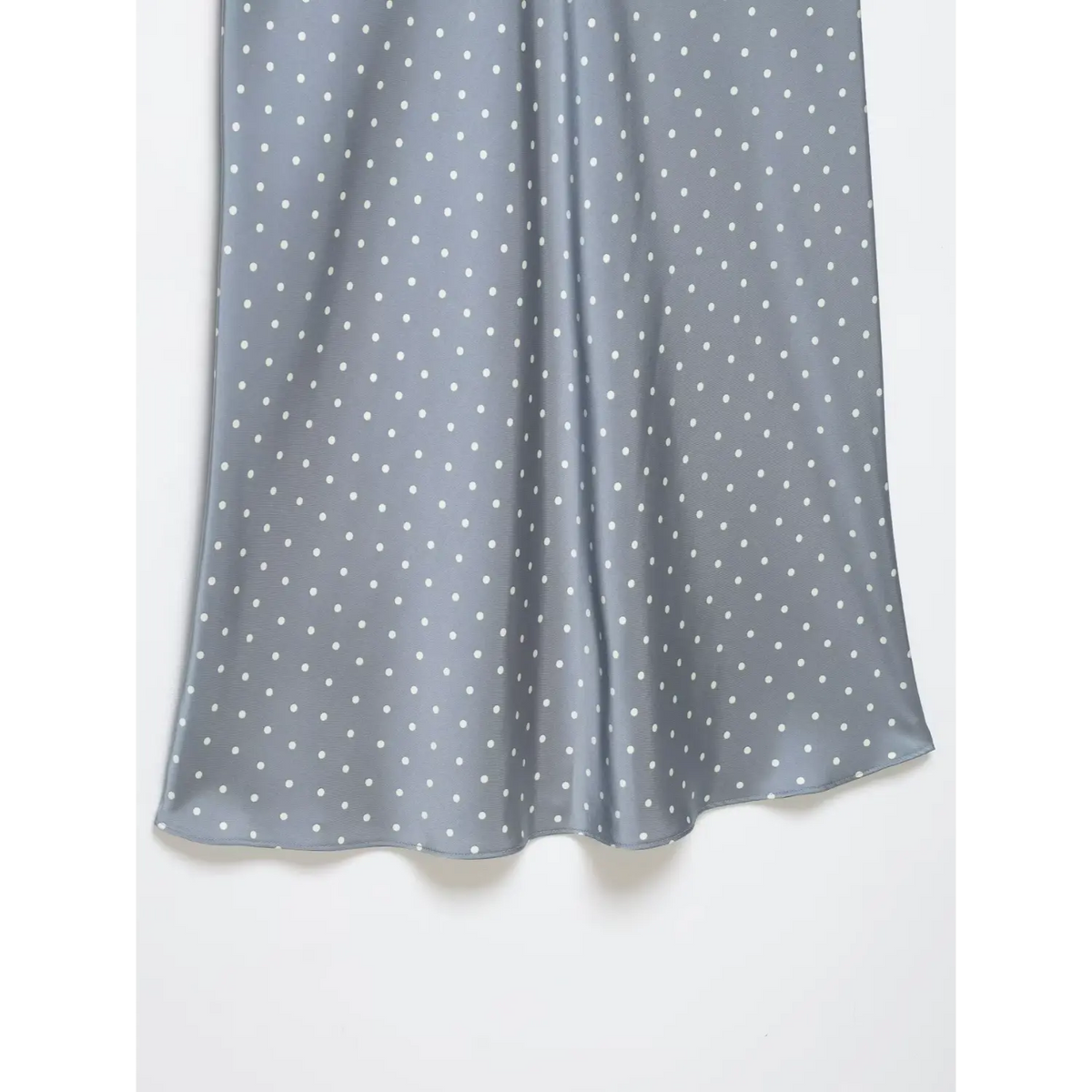 Close-up of satin skirt drape at hem