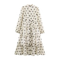 Full look of polka dot maxi dress with stand collar, puff sleeves and layered ruffle skirt