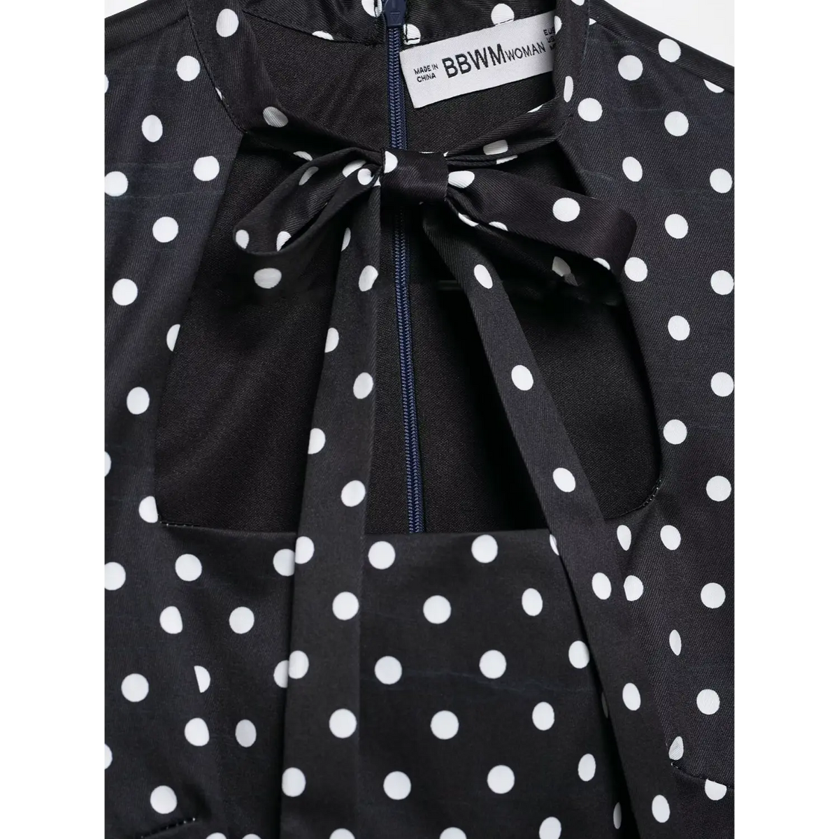 Close-up of neck label, back zipper and tie bow