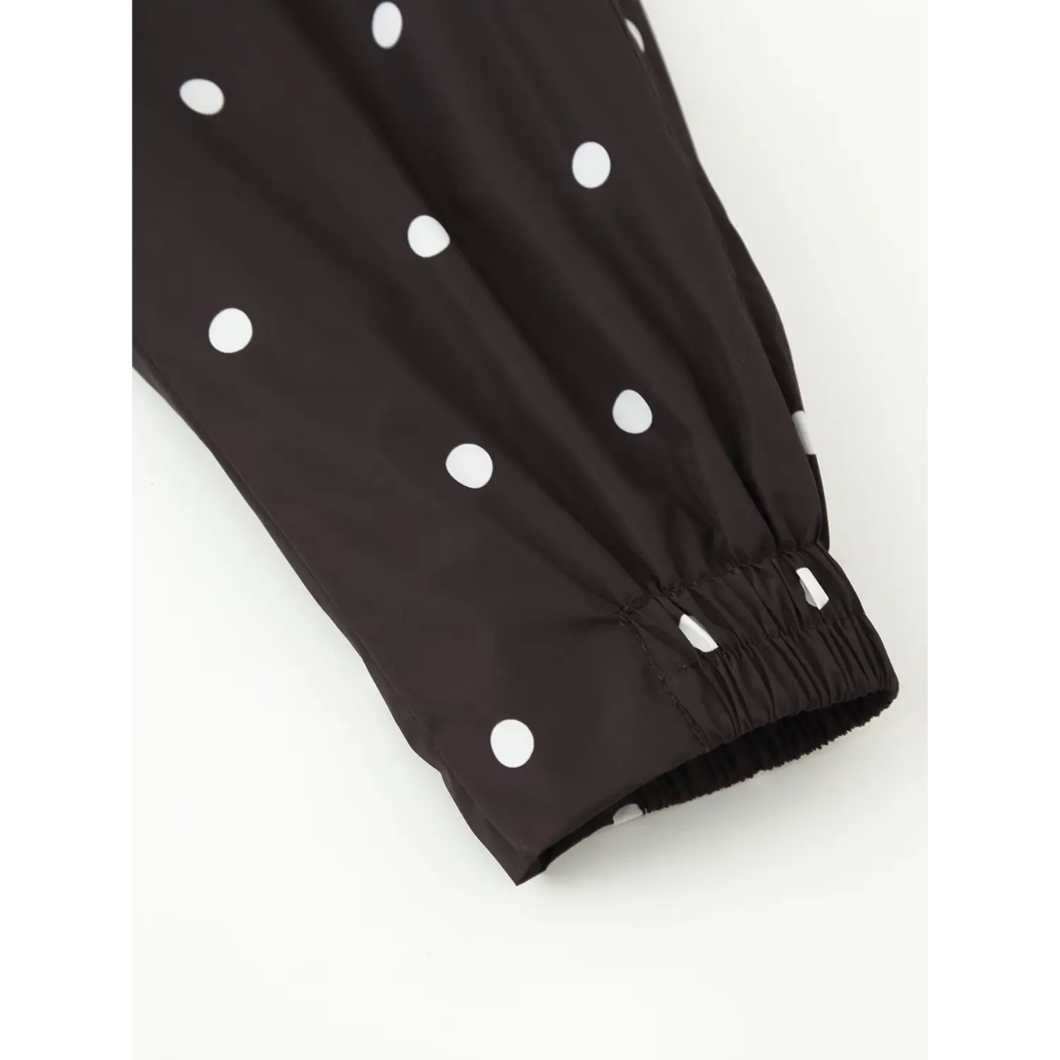 Elastic gathered cuff close‑up, long sleeve cuff detail of polka dot windbreaker jacket