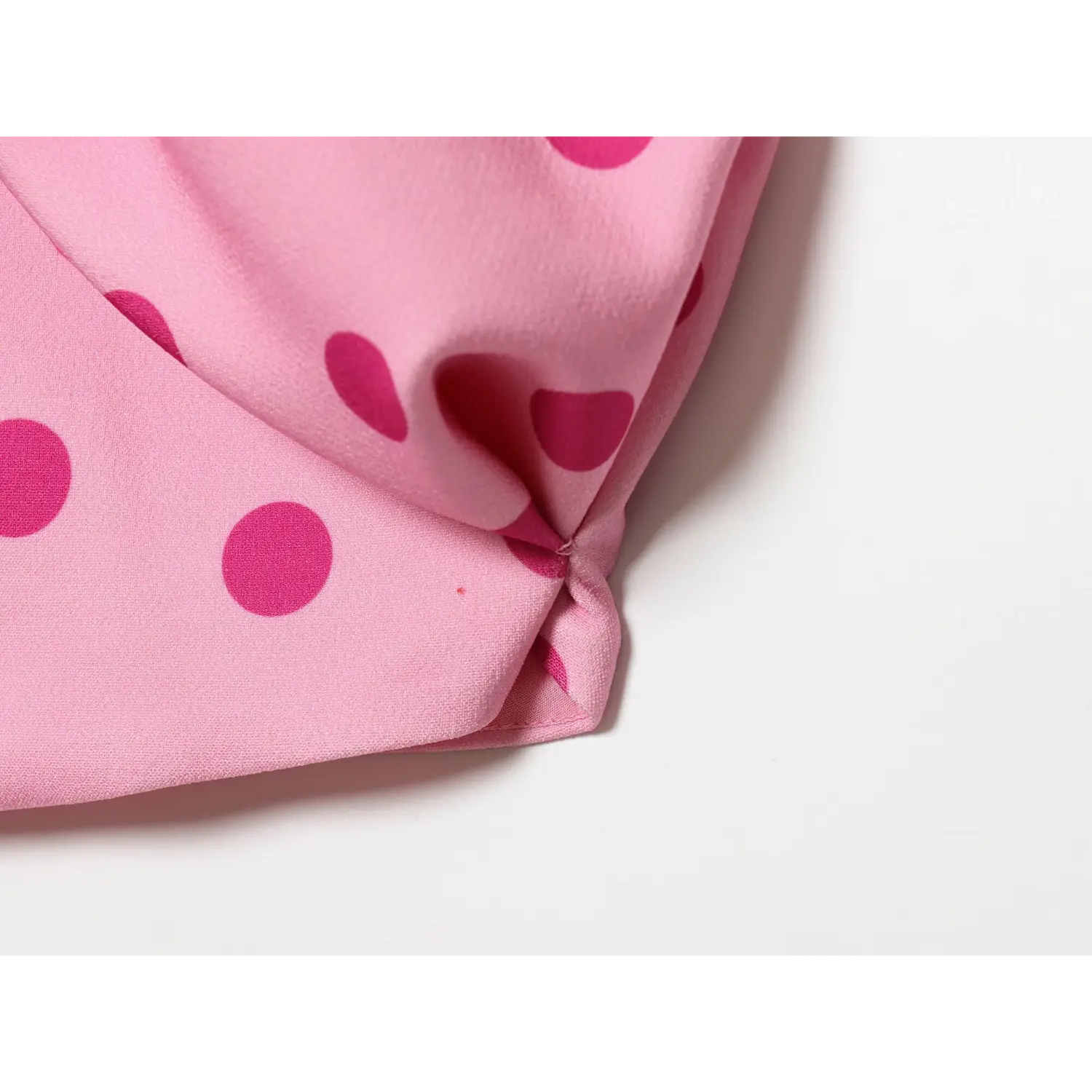 Extreme closeup lightweight woven fabric, two tone pink dot print, soft drape texture