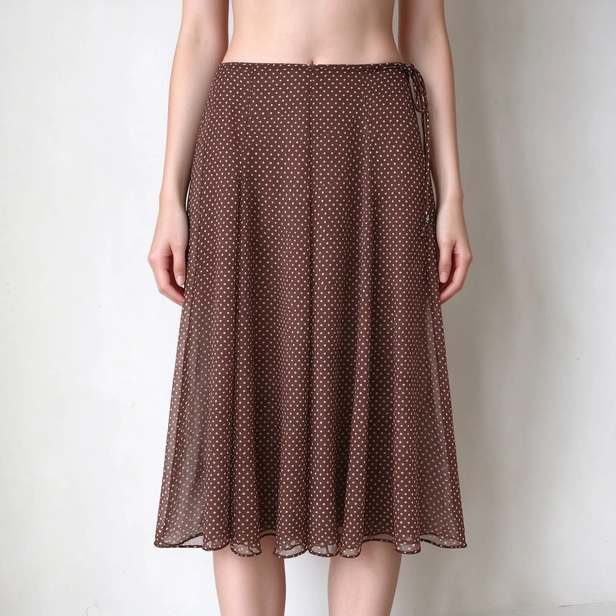 Model wearing polka dot wrap tie chiffon midi skirt, cropped front view