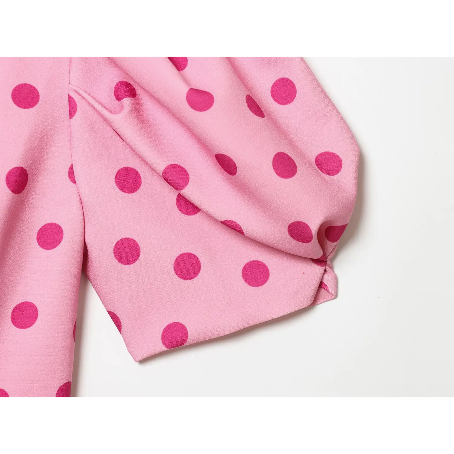 Side view finished sleeve hem, gathered puff silhouette, polka dot woven fabric