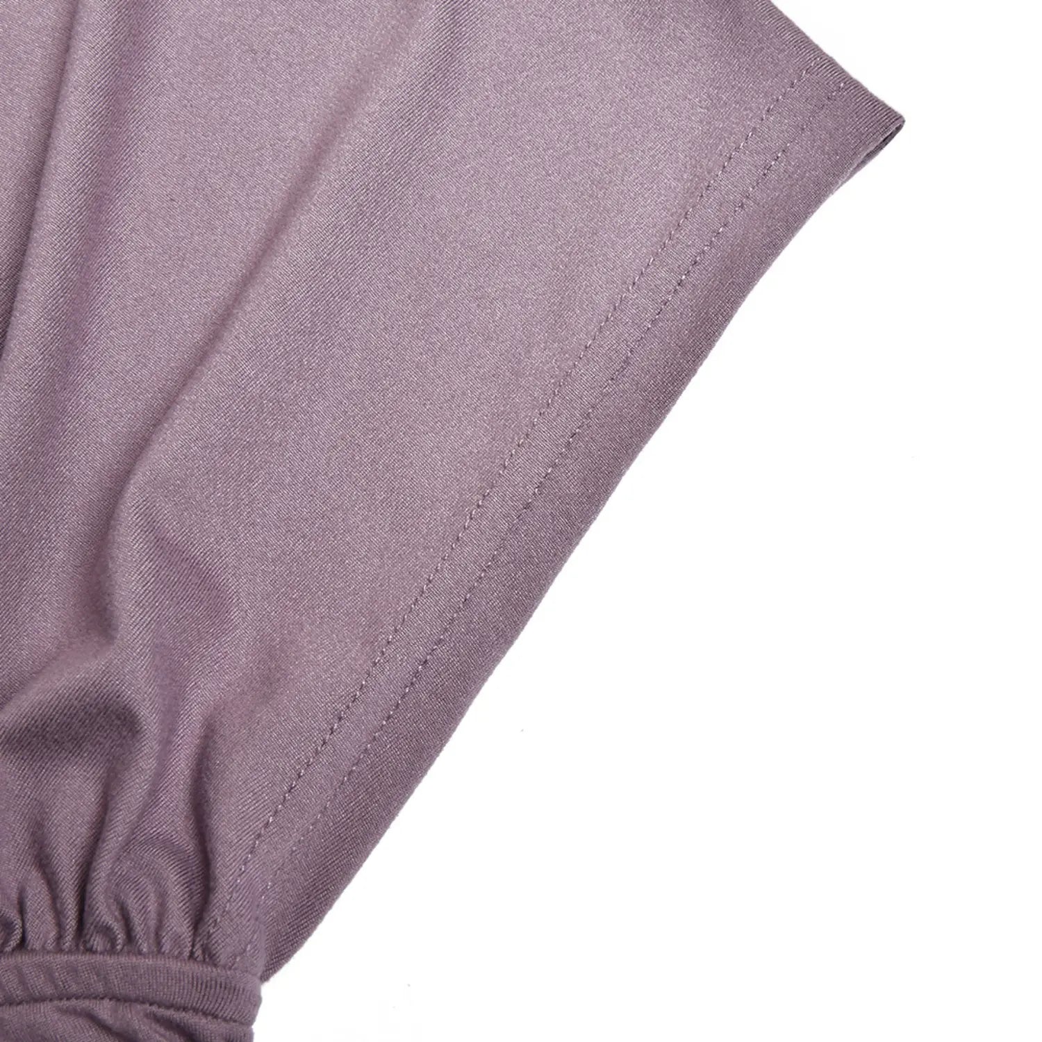 Close up stitching detail of short flutter sleeve on dusty purple dress