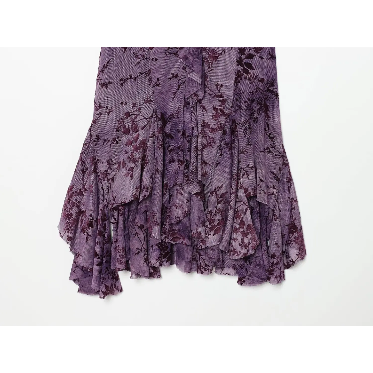 Close‑up of irregular ruffle skirt hem on purple floral mesh cami mini dress