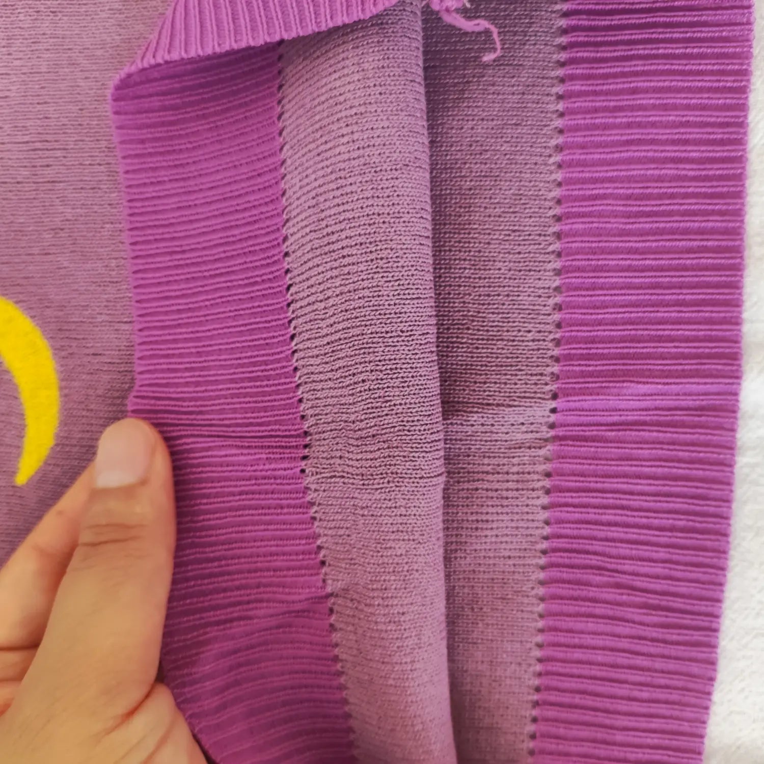 Close‑up inner knit fabric and ribbed band texture of purple strapless tube top