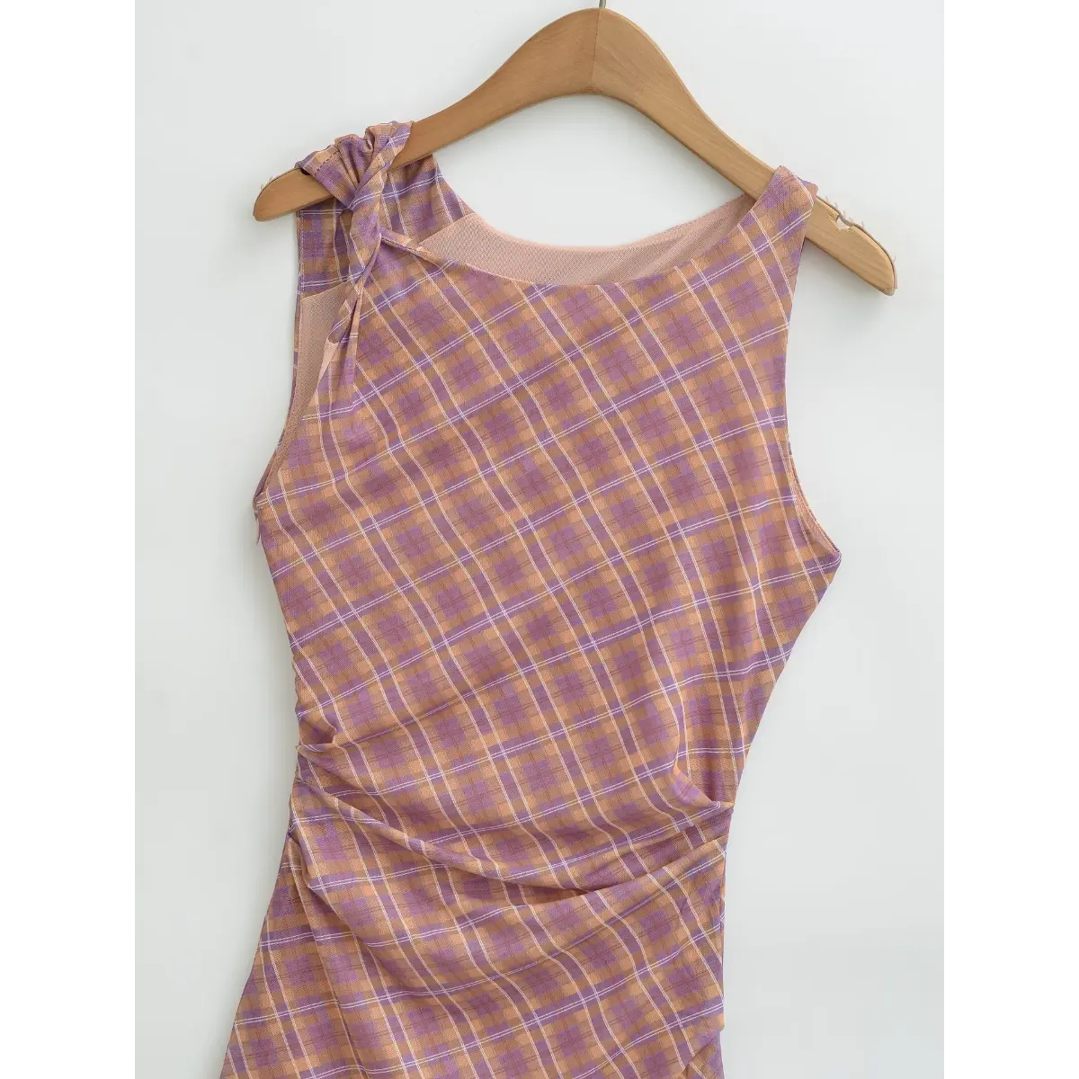  Full front view of the dress, showing the twisted strap, ruched side detail, and form-fitting silhouette.