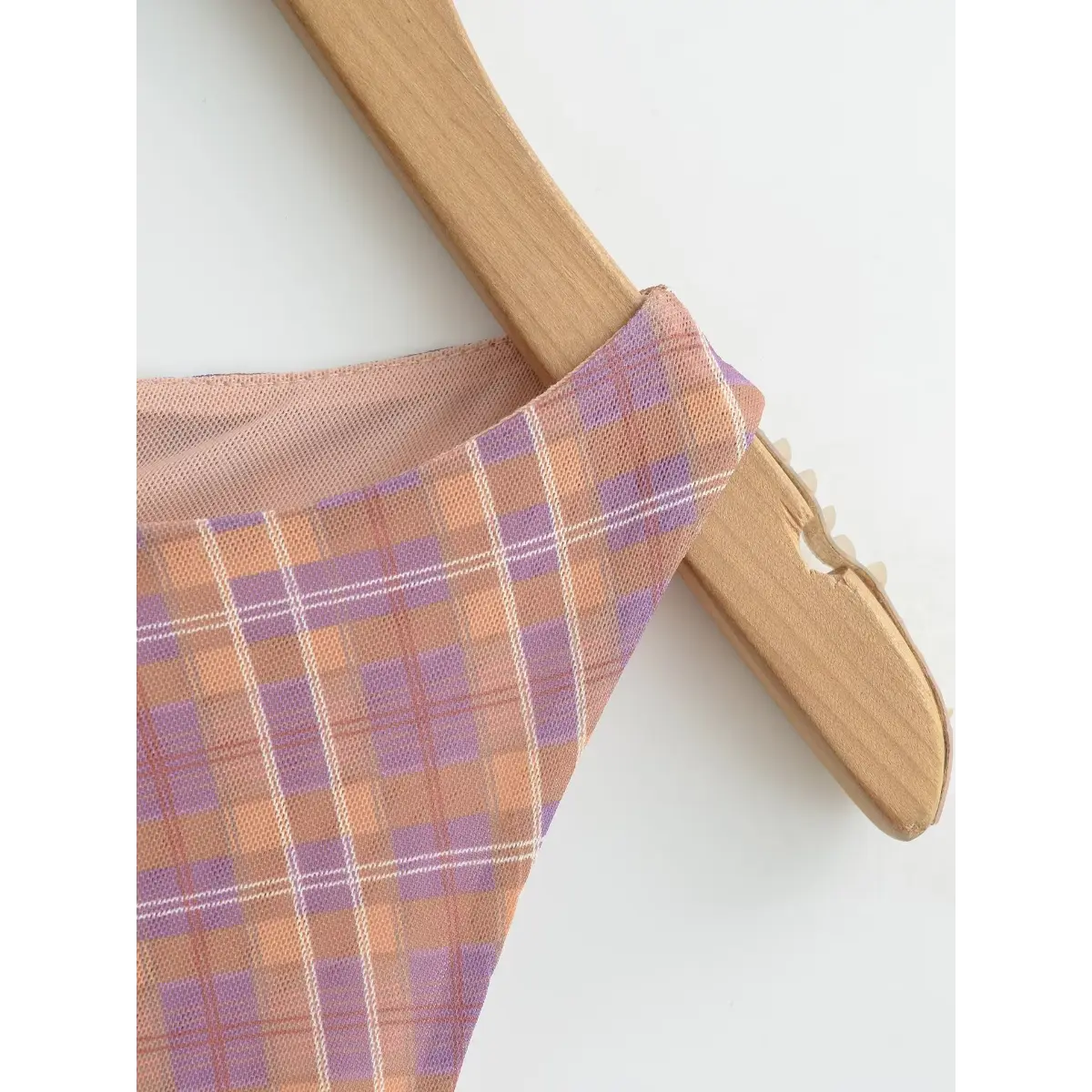 Close-up of the round neckline, featuring the smooth mesh fabric and clean finish.