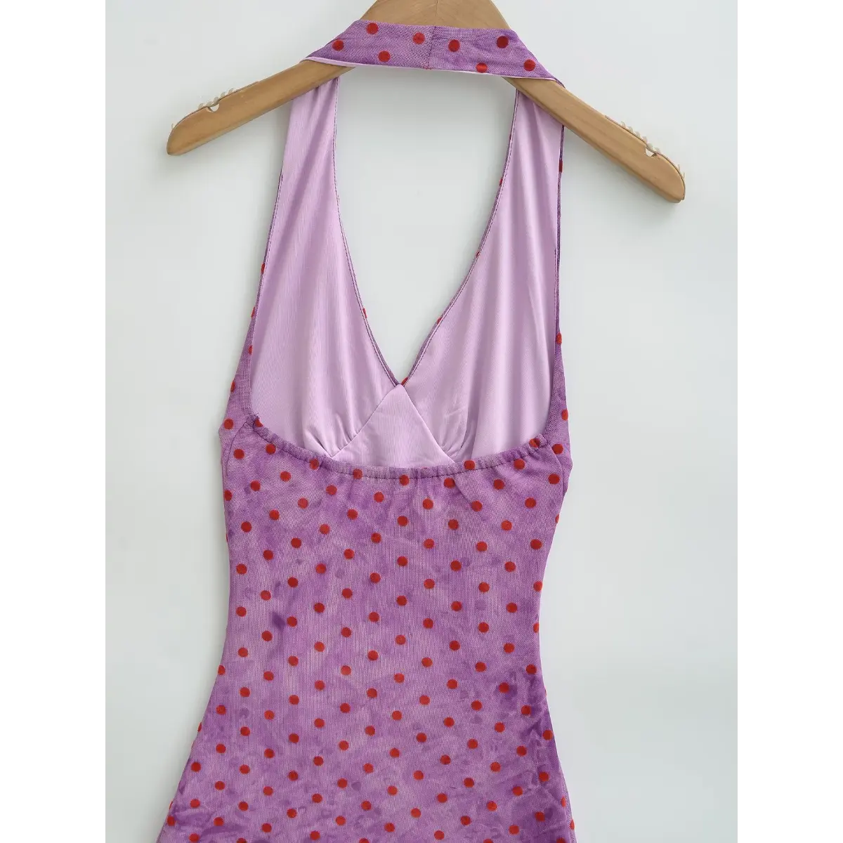 Close-up of the halter neckline, showing the matching scarf tie and light purple lining.