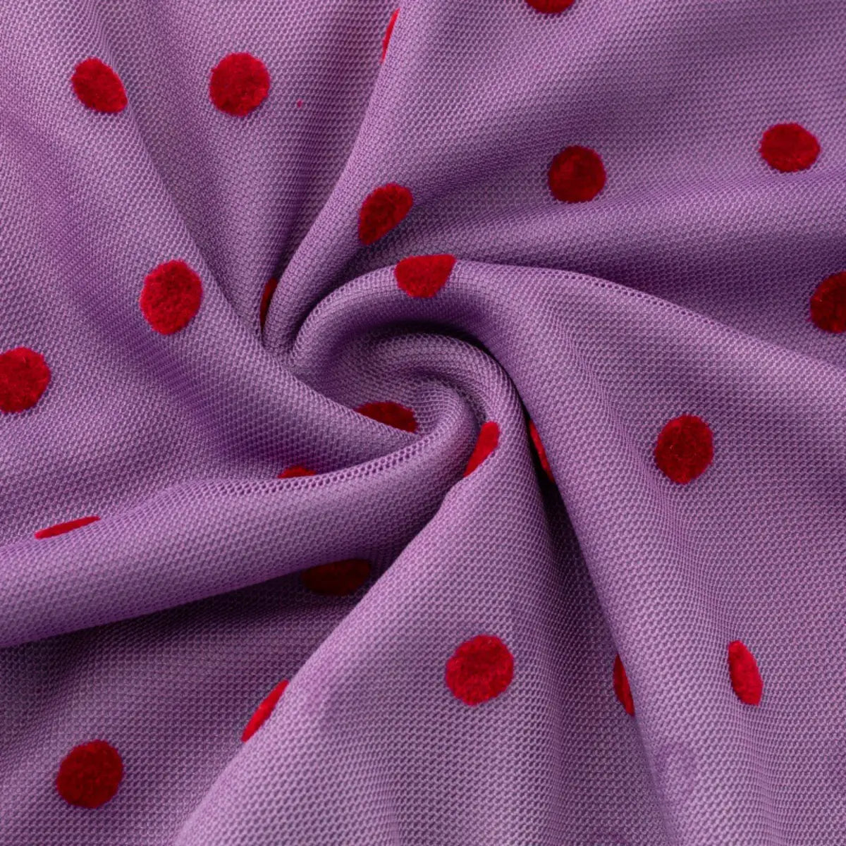 Close-up of the purple mesh fabric with red polka dots, highlighting the texture and print.