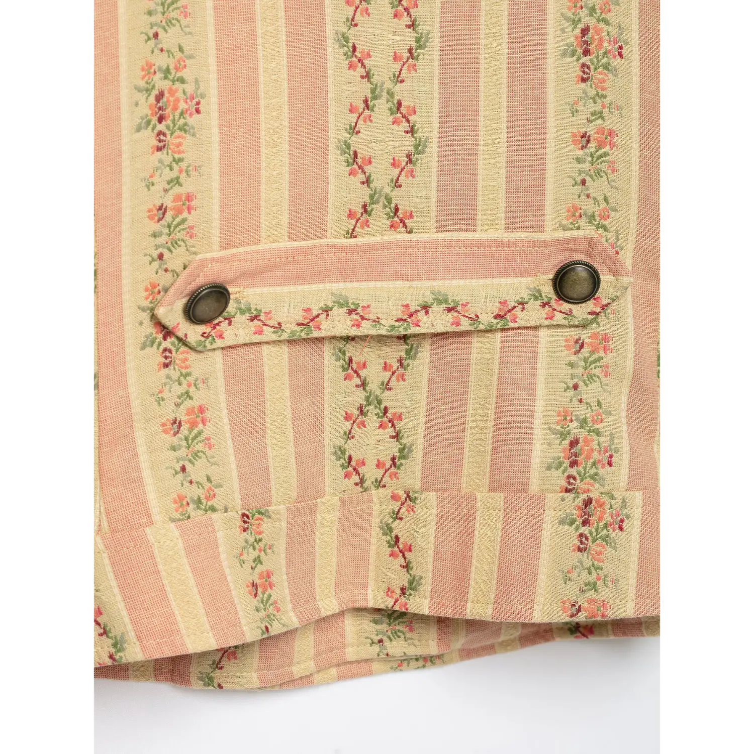 Close-up rear double metal button tab, floral stripe woven fabric texture of vintage jacket