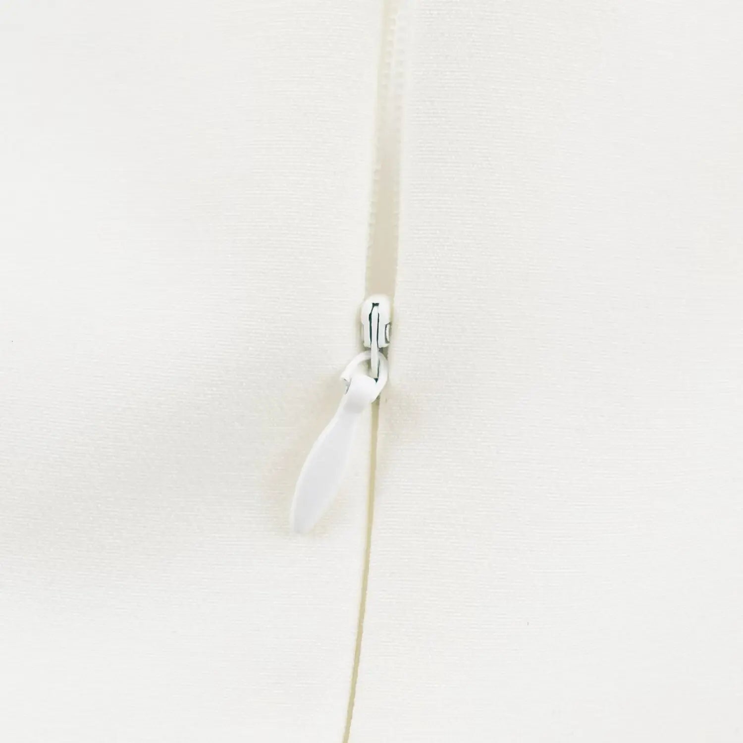 Close-up shot of back invisible zipper with fabric pull tab