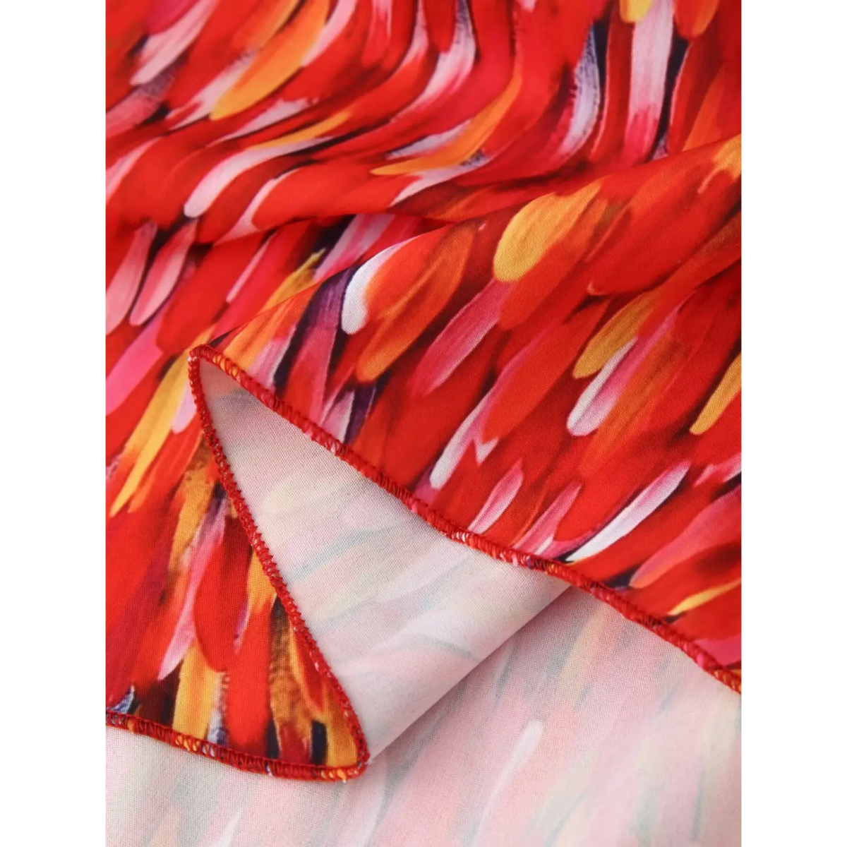 Close‑up hem fabric and inner lining finish red halter tiered maxi dress