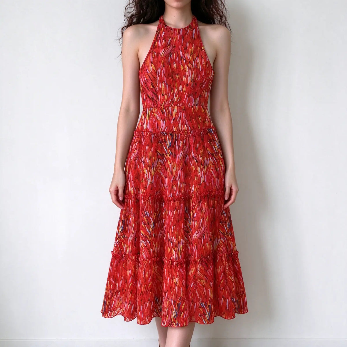 Model in red abstract brush print halter maxi dress, tiered ruffled chiffon fabric, high halter neck, fitted waist, long maxi length skirt, white backdrop