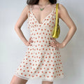 White base hand-drawn red apple print tie strap slip mini dress full body model shot, lapel V neck adjustable self-tie thin straps high waist A-line short silhouette, scalloped lace hem, matched with shoulder bag sweet casual daily street outfit display